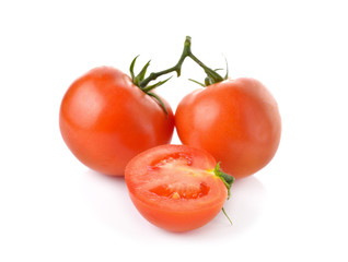 whole and half cut tomato with stem on white background
