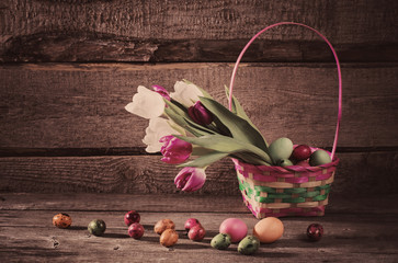 flowers and easter eggs on wooden background