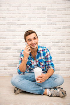 Young smiling man ralking by mobile phone