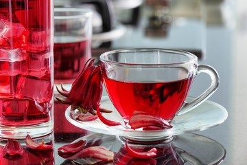 Cup of hibiscus tea (rosella, karkade) on kitchen table