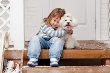 Girl with a dog on the front porch
