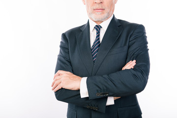 Close up portrait of old businessman with crossed hands