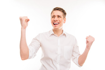 Happy young man screaming and showing fists