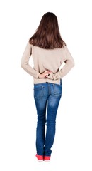 back view of standing young beautiful  brunette woman.