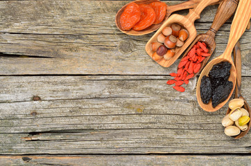Mix of dried fruits and nuts - symbols of judaic holiday Tu Bishvat. Superfood. Copyspace background. Top view.