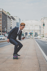 Young handsome Asian model riding his skateboard