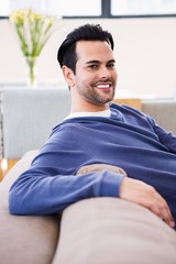 Handsome man day dreaming on the couch