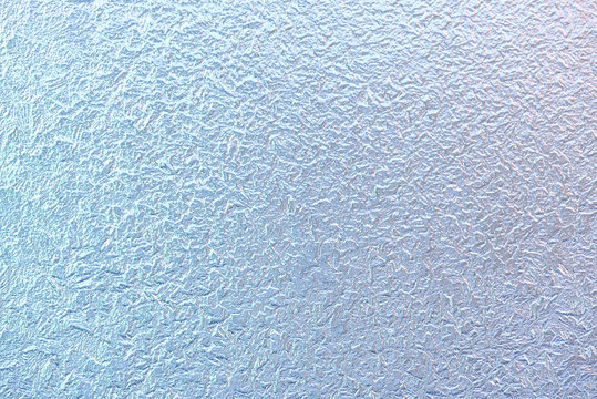 Frost patterns on window glass in winter. Frosted Glass Texture. Blue