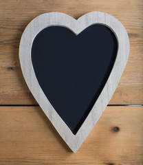 A wooden heart with chalkboard center
