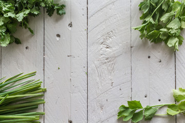 Fresh parsley and spring onions  on wooden background