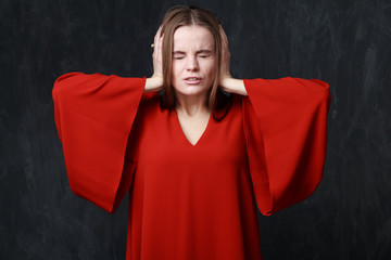 crying woman in res dress, dramatic pose, hands on the head