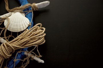 Creative Marine and Navy Elements on Wooden Background like Rope,Shells,Ship Wheel and Lifebuoy