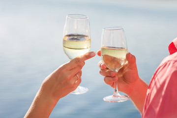 Happy couple drinks champagne on a yacht