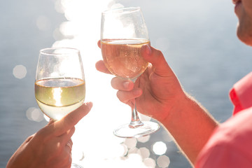 Happy couple drinks champagne on a yacht