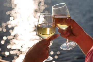 Happy couple drinks champagne on a yacht