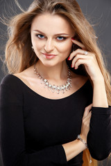 Close-up portrait of beautiful young woman with luxury jewelry and perfect make up. Fashion beauty portrait