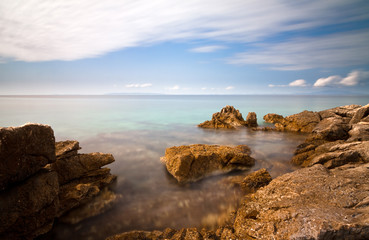 Looking over the ocean at the rocky Croatian coast, long exposure.
