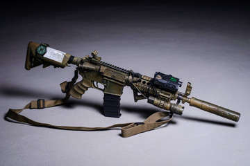 .Automatic rifle with silencer and laser sight/Painted assault automatic rifle with silencer, laser sight and tactical flashlight