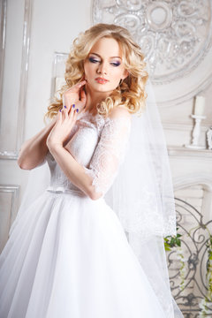photo of a beautiful blonde bride in a luxurious wedding dress in elegant expensive interior