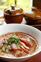 Spicy TOM YAM noodle soup with pork, lemongrass, chili pasted an