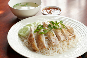 Steamed chicken with rice, soup, and spicy sauce
