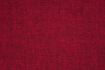 Closeup detail of red fabric texture background.