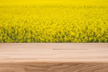 empty wooden planks with blurred background blooming yellow rape