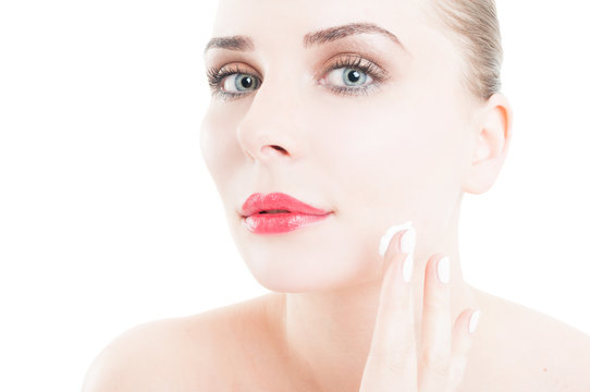 Woman applying face cream on skin care concept