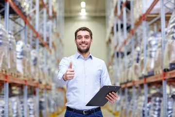 happy man at warehouse showing thumbs up gesture