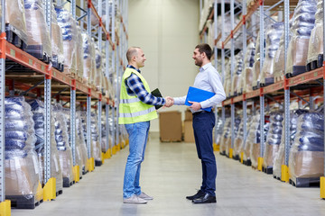 worker and businessmen with clipboard at warehouse