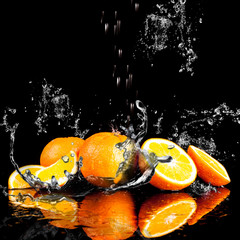 Naklejka na ściany i meble Orange fruits and Splashing water