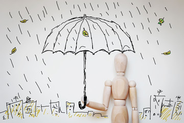Man standing under umbrella in raining. Abstract image with wooden puppet