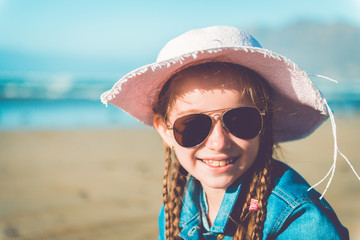 little girl in a hat on the  beach