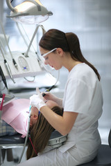 Profile of a young dentist providing restorative teeth's treatment - 101205780