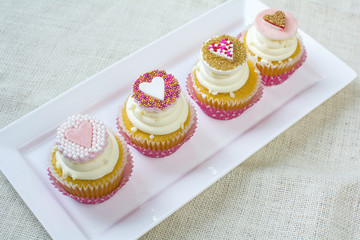 Heart fondant with sprinkles on vanilla cupcake for valentines