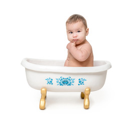 funny baby sitting in white  bath