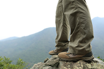 young woman hiker hiking at mountain peak