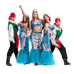 Carnival dancer team dressed as mermaids and pirates.  Isolated on white background in full length.