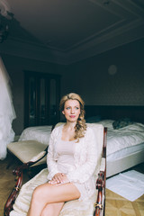 Young beautiful blonde bride applying wedding professional make-up