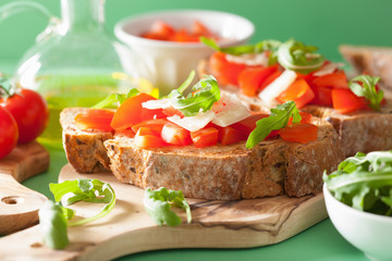 italian bruschetta with tomatoes parmesan arugula