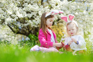 Two adorable little sisters having fun on Easter day