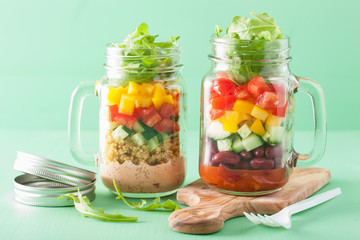 vegan quinoa bean vegetable salad in mason jars