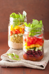 vegan quinoa bean vegetable salad in mason jars