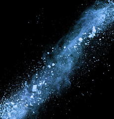 Explosion of blue powder on black background