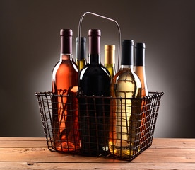 A Wire Shopping Basket Filled With Wine Bottles