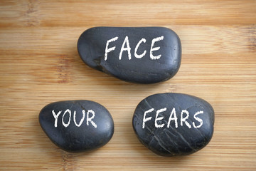 Obraz na płótnie Canvas Face your fears, three words motivational slogan conceptual