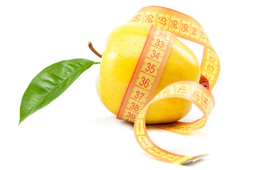 Fresh yellow apple and measuring tape.