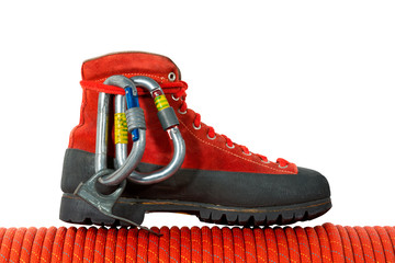 Climbing Equipment on White Background / Rock climbing equipment with mountaineering boot, two carabiners, a piton and a red rope. Isolated on white background