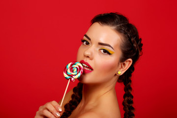 young woman with heart shaped pink lollipop