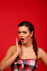 Surprised woman with mouth open. Makeup. Beauty woman with red background. Open mouth Emotions